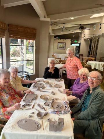 Residents at The Oaks of Pasadena senior living community participating in a ceramics class, creating pottery and enjoying hands-on artistic activities