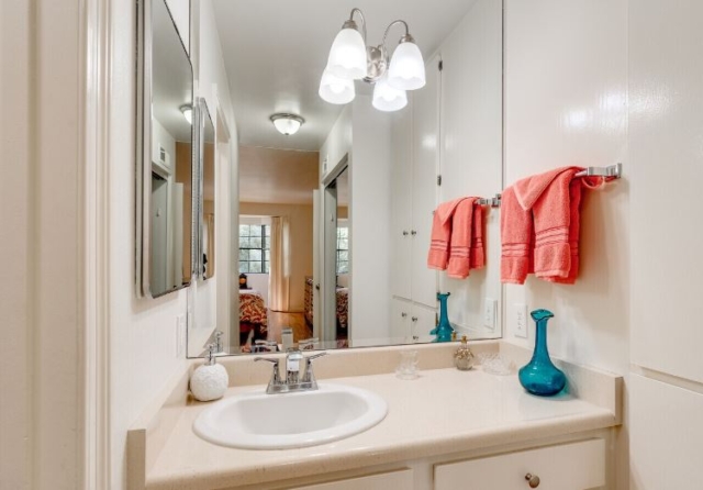 Bathroom at The Oaks of Pasadena senior living community featuring spacious vanity and ample cabinet storage — part of our thoughtfully designed one- and two-bedroom apartments
