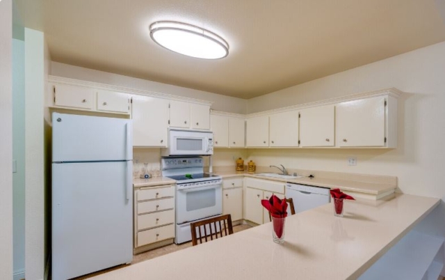 Fully equipped kitchen in The Oaks of Pasadena senior living apartment featuring all major appliances